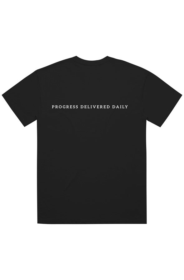 A black short-sleeve crewneck t-shirt with the phrase 'PROGRESS DELIVERED DAILY' printed in white capital letters across the chest, displayed on a solid white background.