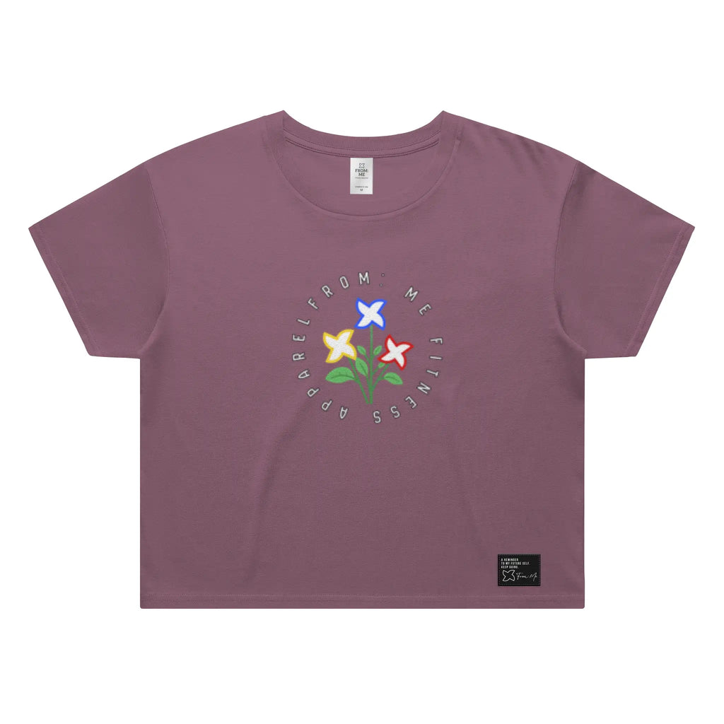 Purple t-shirt with floral graphic and text on a white background