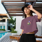 Woman wearing a purple t-shirt with a colorful design outdoors by a pool