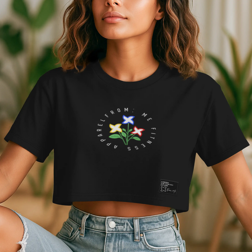 Person wearing a black t-shirt with a colorful flower design and text.