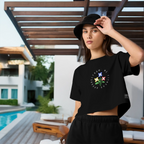 Woman wearing a black t-shirt with a colorful design outdoors by a pool