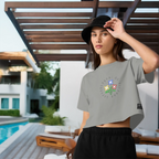 Woman wearing a gray t-shirt with text and black shorts, standing outdoors near a pool.