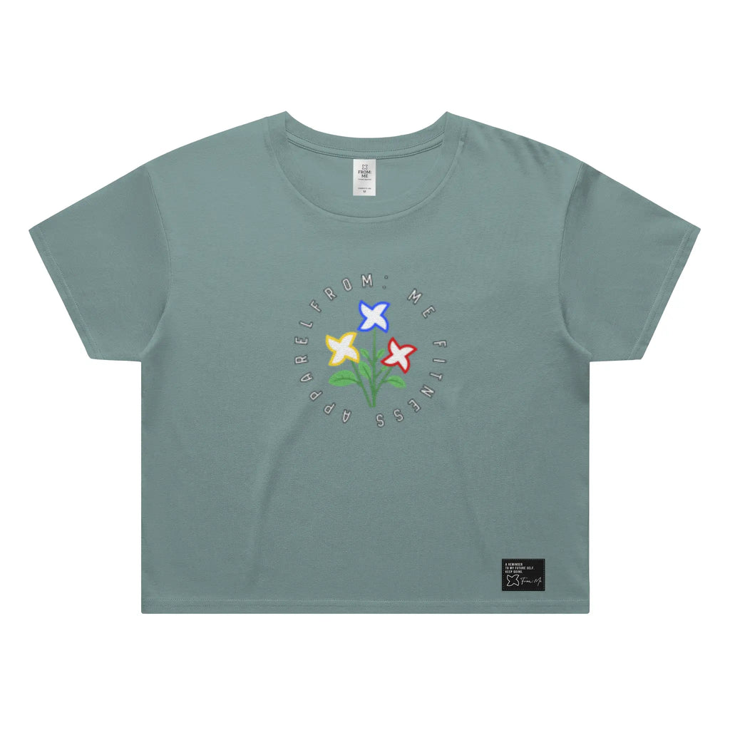 Green t-shirt with colorful floral design and text on a white background