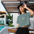 Woman wearing a green t-shirt and black shorts standing by a poolside.