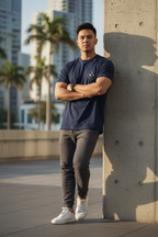 Man standing against a concrete wall with palm trees and buildings in the background | From Me Fitness Apparel