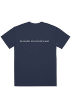 A navy blue short-sleeve t-shirt with the phrase 'PROGRESS DELIVERED DAILY' printed in white across the chest, displayed on a solid white background.