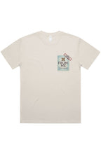A light beige short-sleeve t-shirt with a graphic print on the left chest. The graphic features a light blue ticket stub with the text 'FROM: ME' and a small red and black stamp.