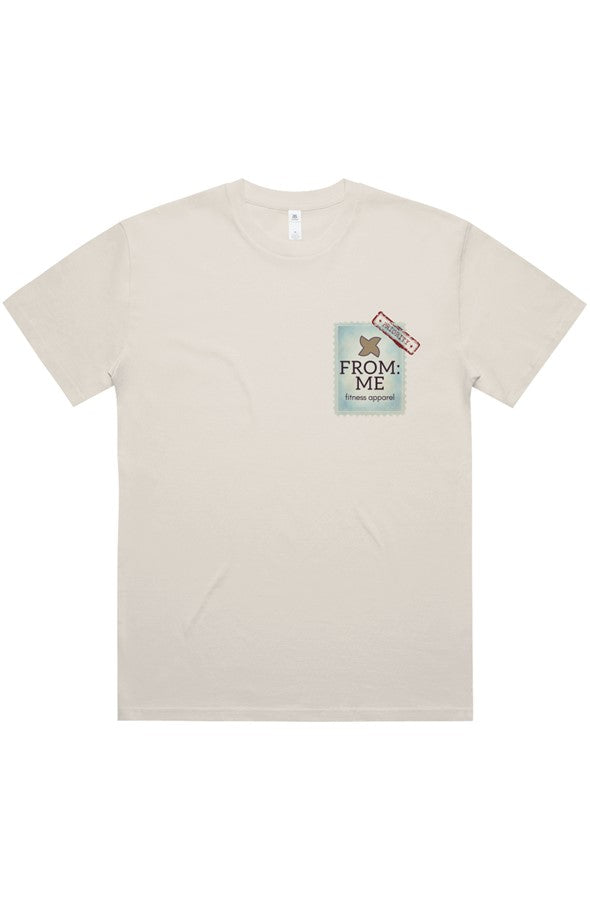 A light beige short-sleeve t-shirt with a graphic print on the left chest. The graphic features a light blue ticket stub with the text 'FROM: ME' and a small red and black stamp.